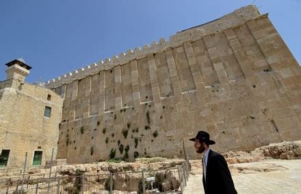 An Ultra Orthodox Jew Walks Outside The Cave Of Machpelah Or Cave Of