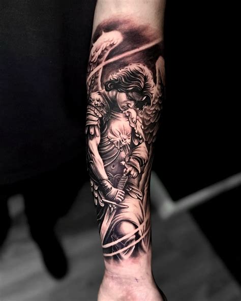 Black And Grey Realism Saint Michael Tattoo On Forearm Archangel Sleeve Idea For Men