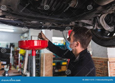 Mechanic Changing The Oil Of The Car Concept Automobile Mechanics